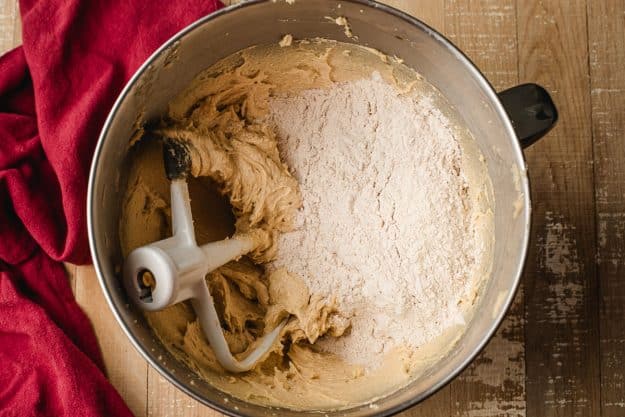 Flour sprinkled over creamed butter, sugar, and eggs.