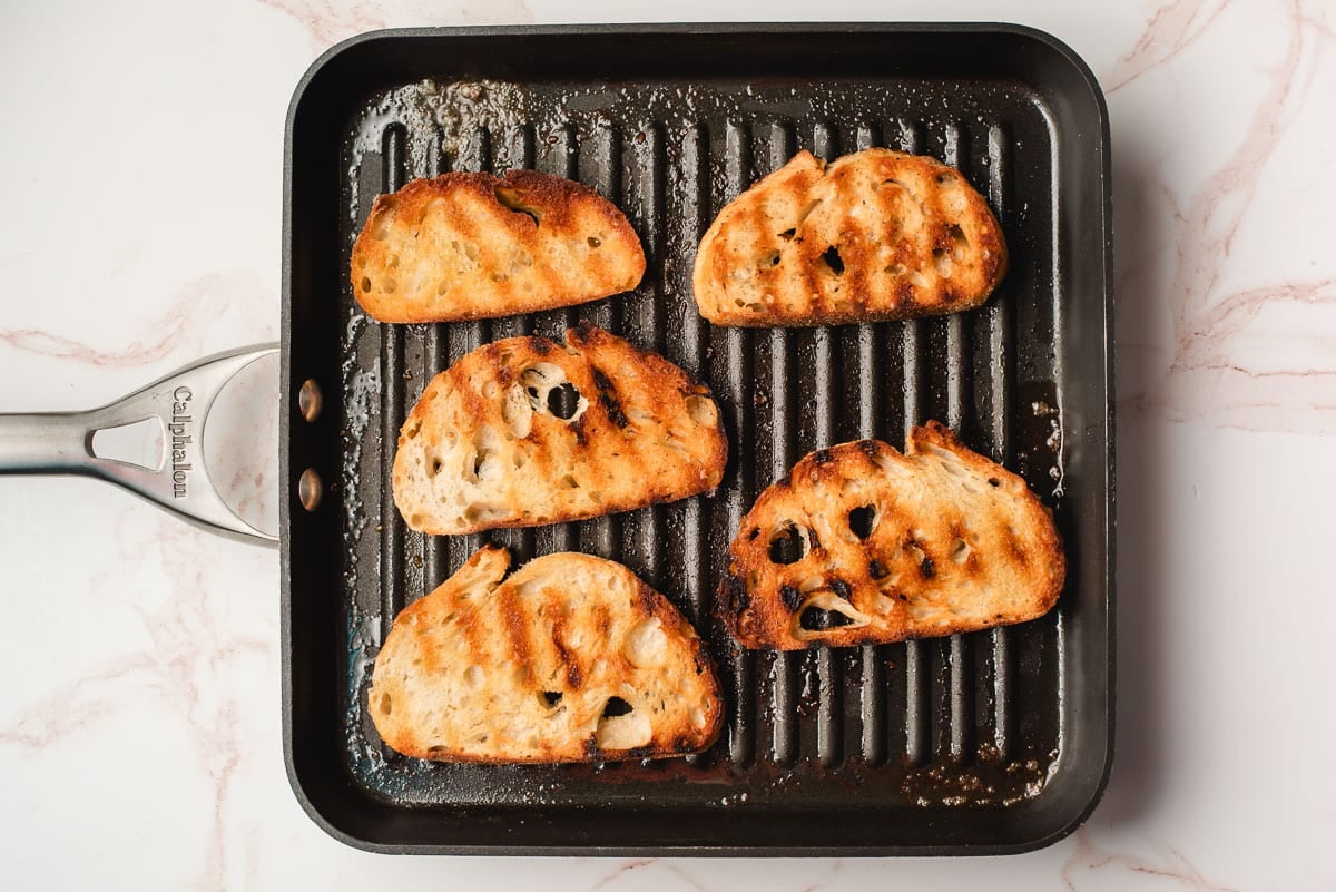 Bread slices grilled in a grill pan.