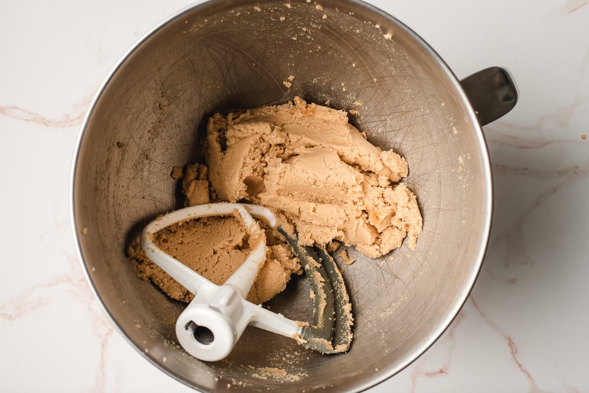 Butter and sugars creamed together in the bowl of an electric mixer.