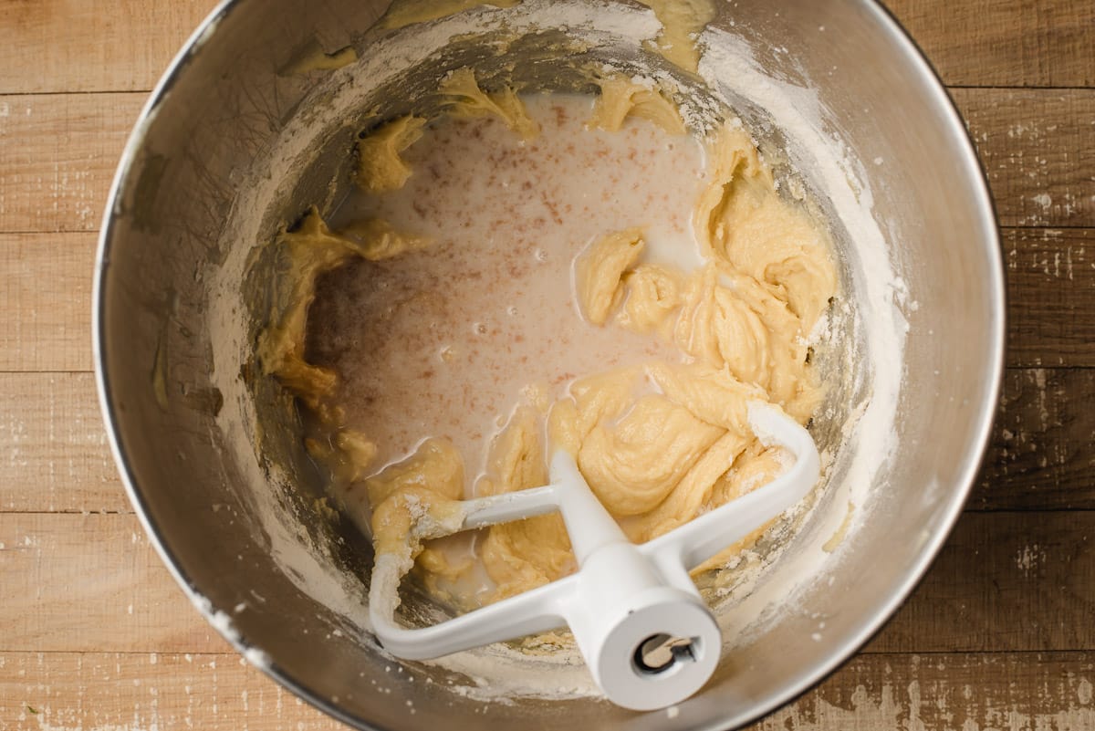 Milk and vanilla being stirred into cake batter.
