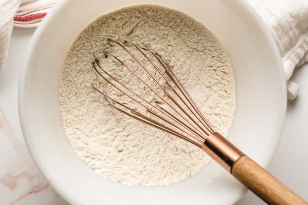 Flour, baking powder, and salt whisked in a bowl.
