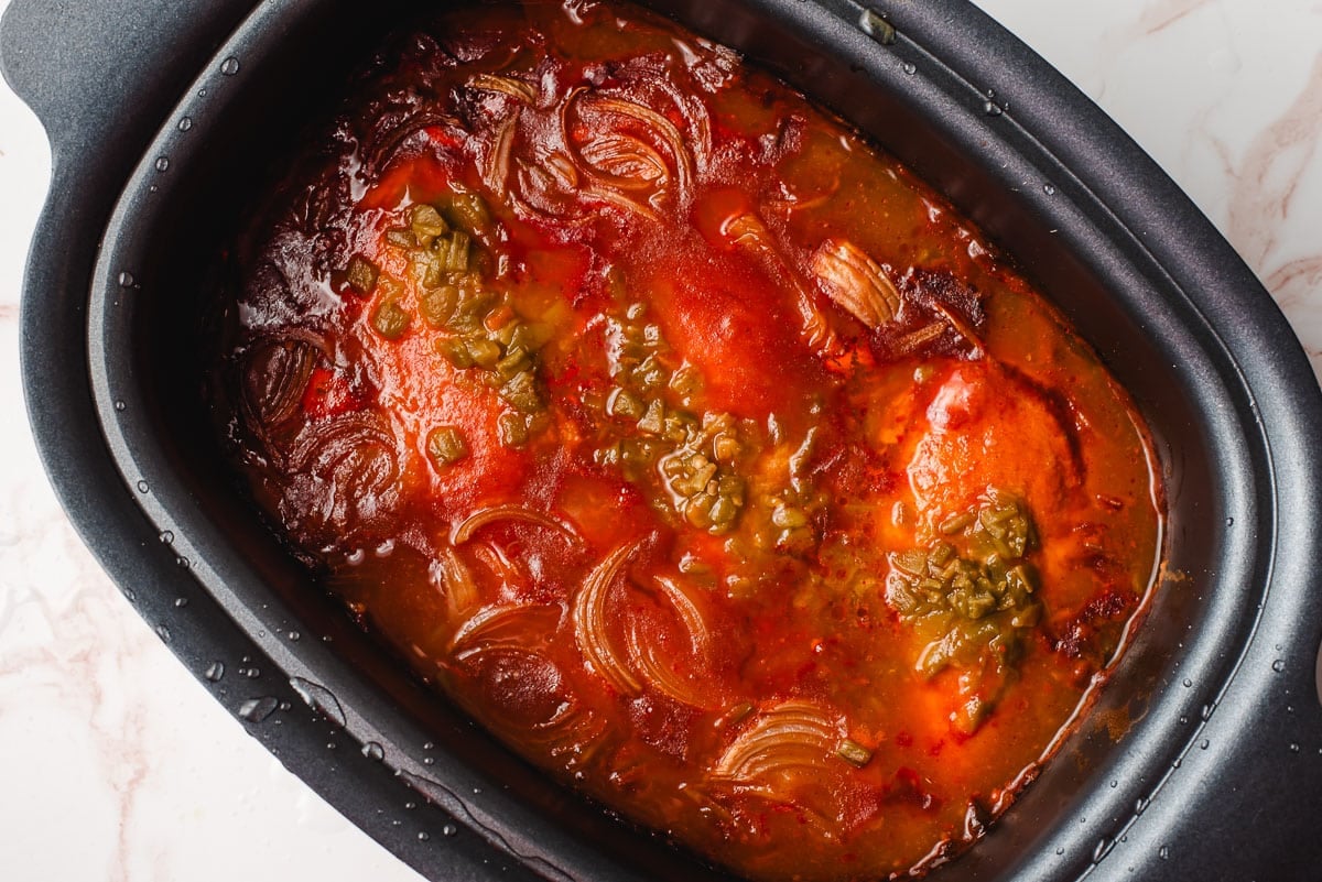 Crock pot full of shredded chicken for enchiladas.