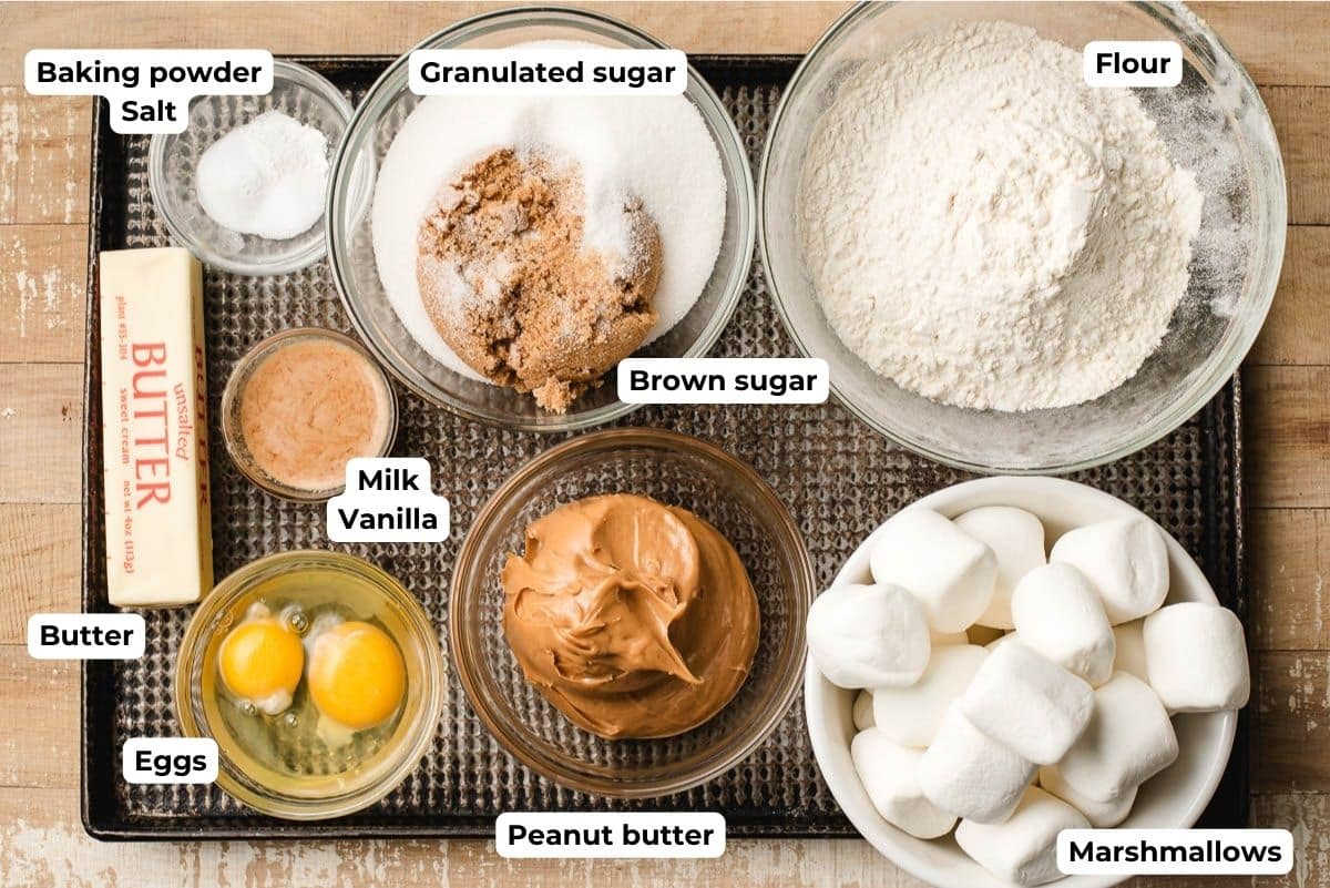 Prep bowls with flour, salt, baking powder, brown and granulated sugar, eggs, butter, peanut butter, and marshmallows.