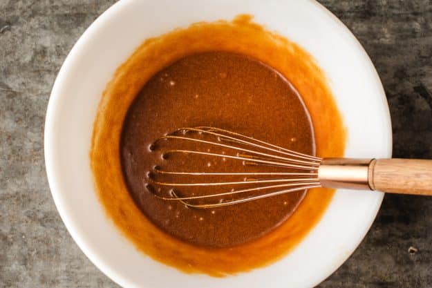 wet ingredients combined in a white mixing bowl