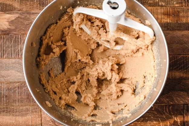 cookie dough mixing in a stand mixer with a paddle attachment