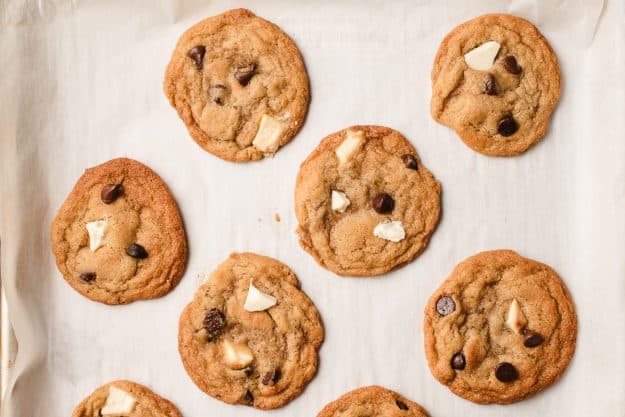 baked cookies on a cookie sheet topped with chocolate chips