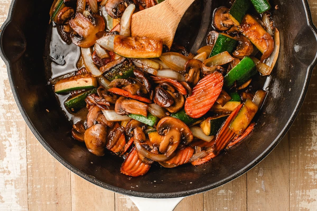 mixing the sauce into the vegetables