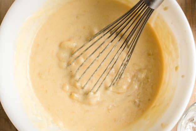 Butter, brown sugar, white sugar, and eggs whisked together in a mixing bowl