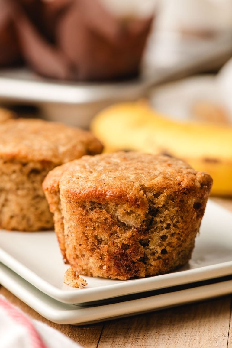 Sour cream banana muffin sitting on a white plate.