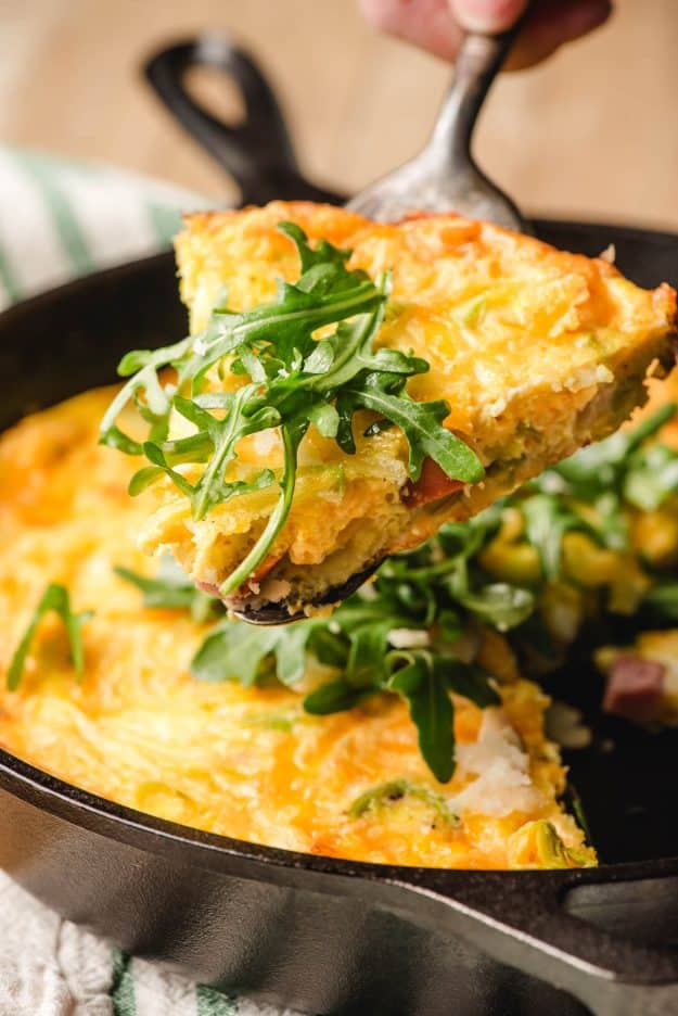 Slice of ham and cheddar frittata with leeks.