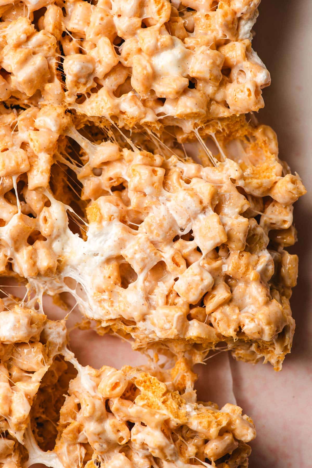 Captain Crunch Bar pulling away from the pan, showing gooey marshmallow strings.
