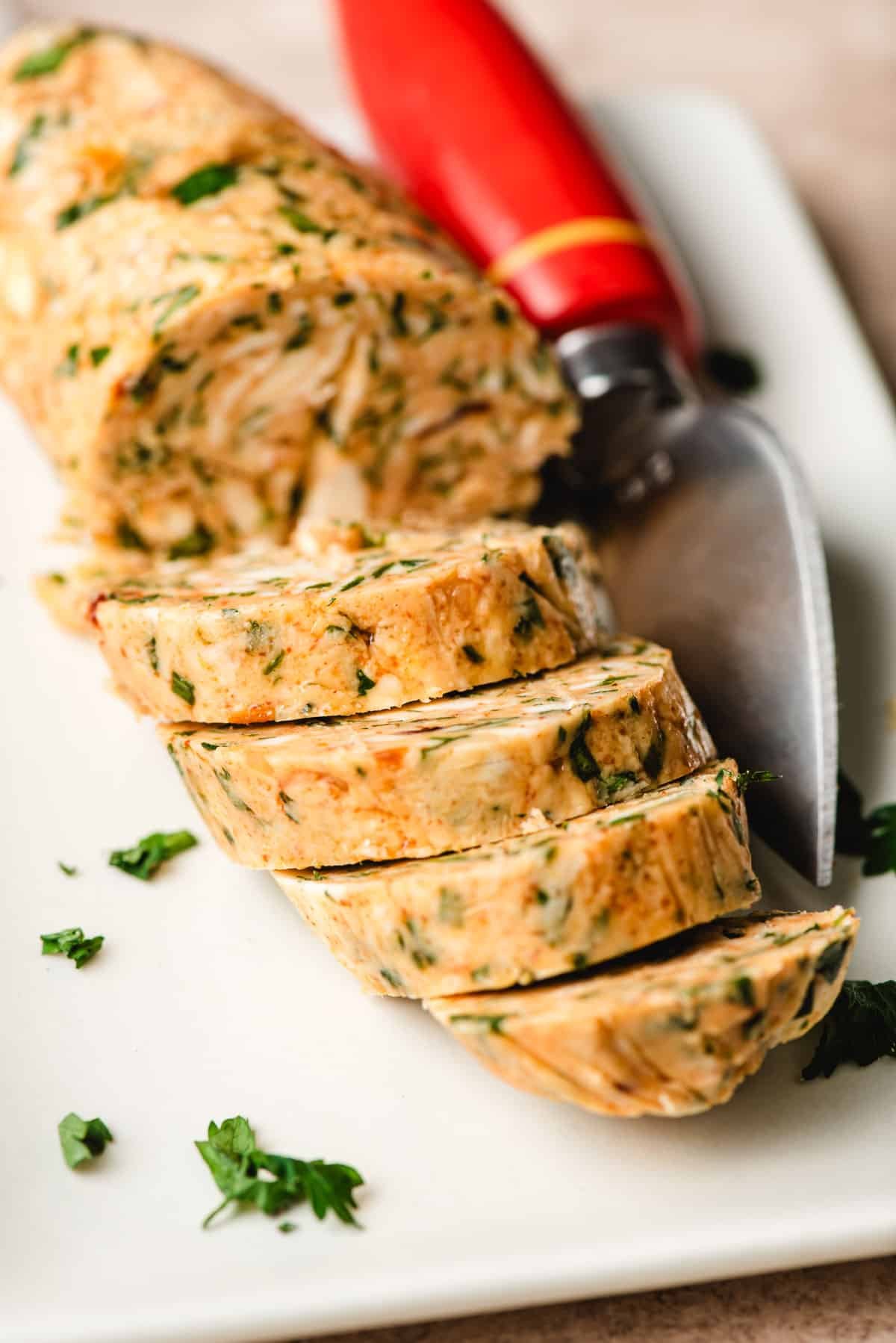 Slices of cowboy butter on a white plate.
