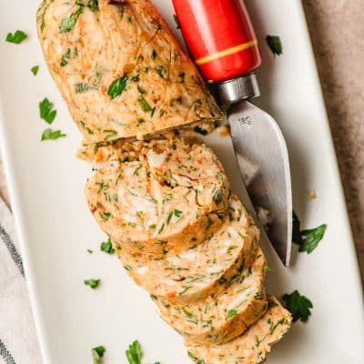 Cowboy butter sliced on a platter with a serving knife.