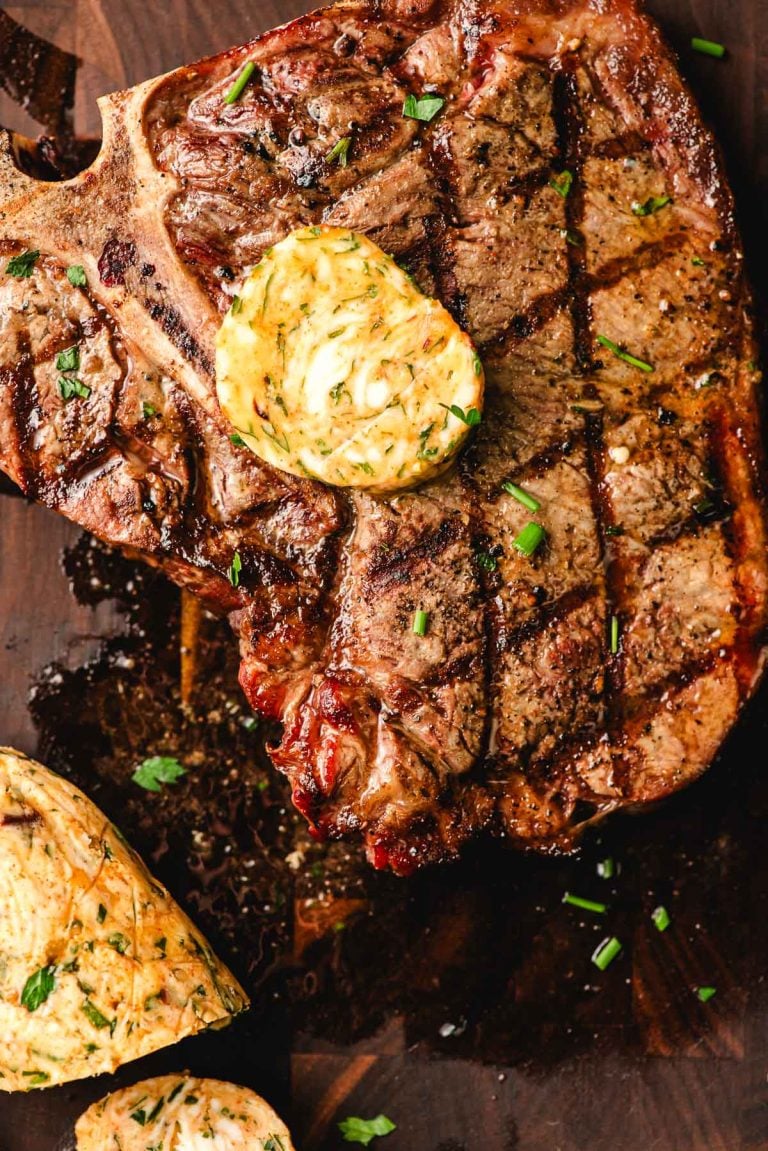 Cowboy butter on top of a grilled T-bone steak.