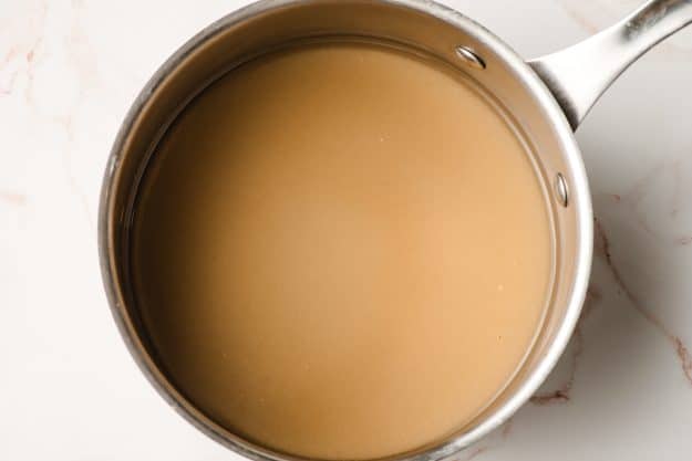 Sugar and water combined in a sauce pan.