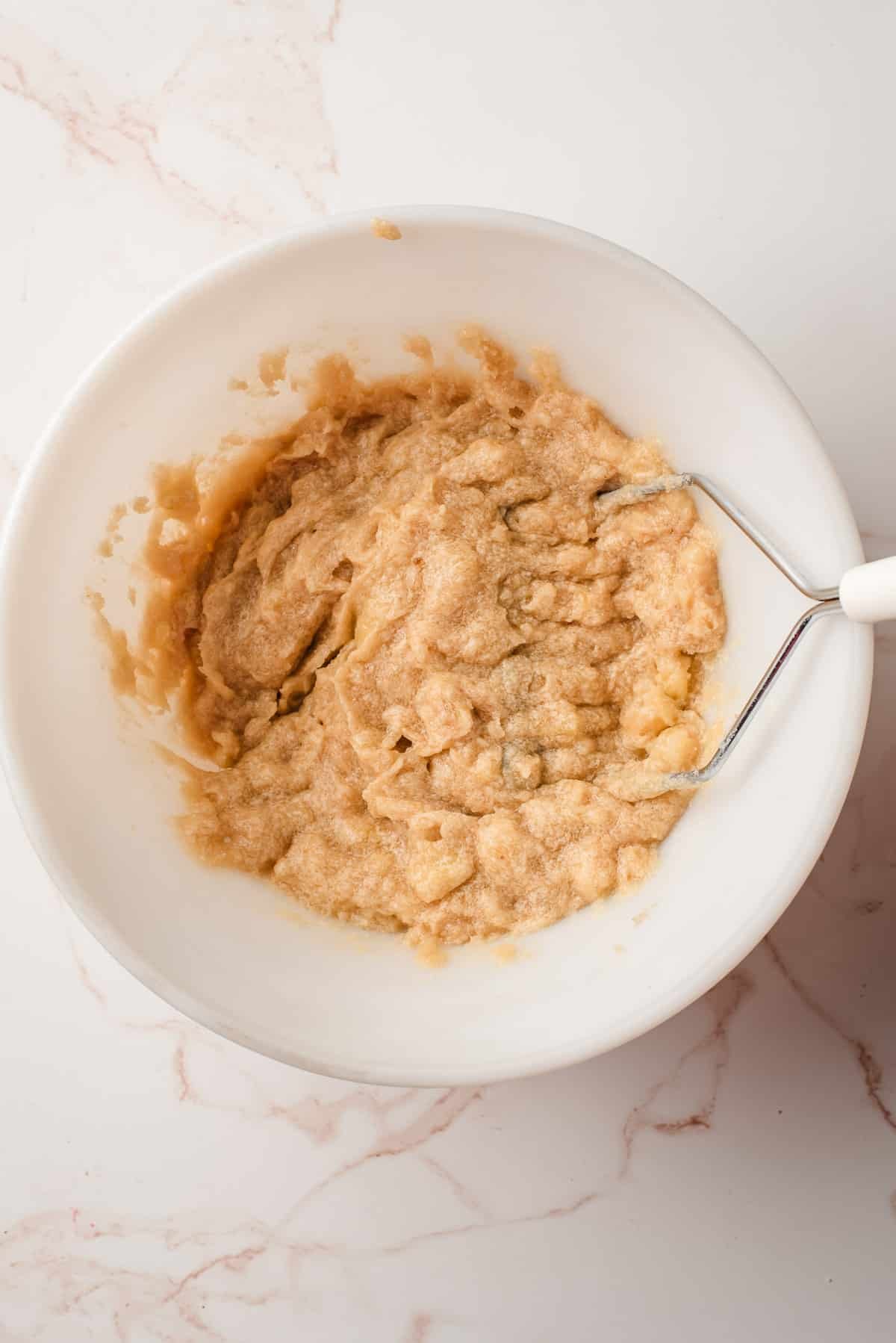 mashing banana into the butter mixture