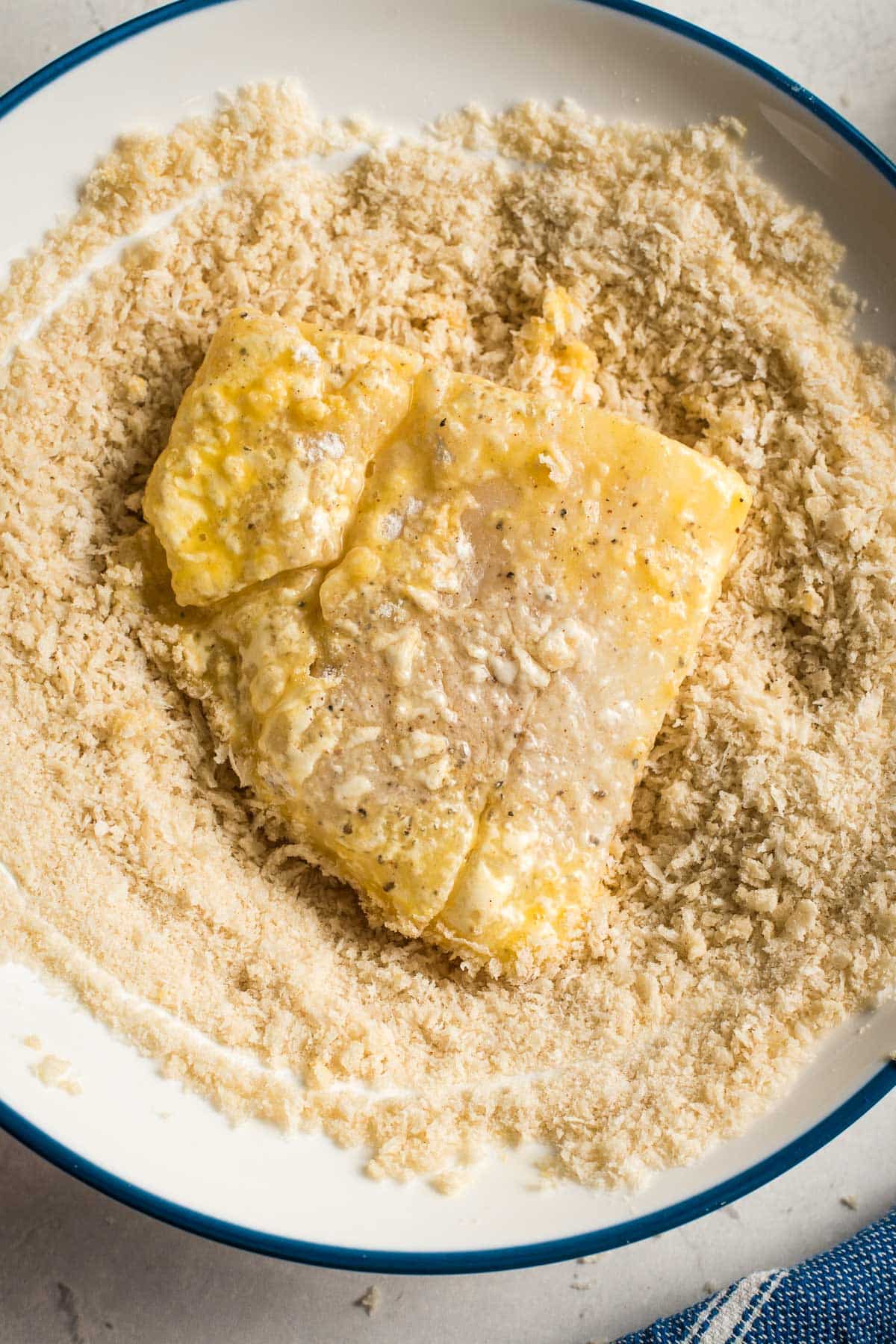 coating the cod filet with panko 