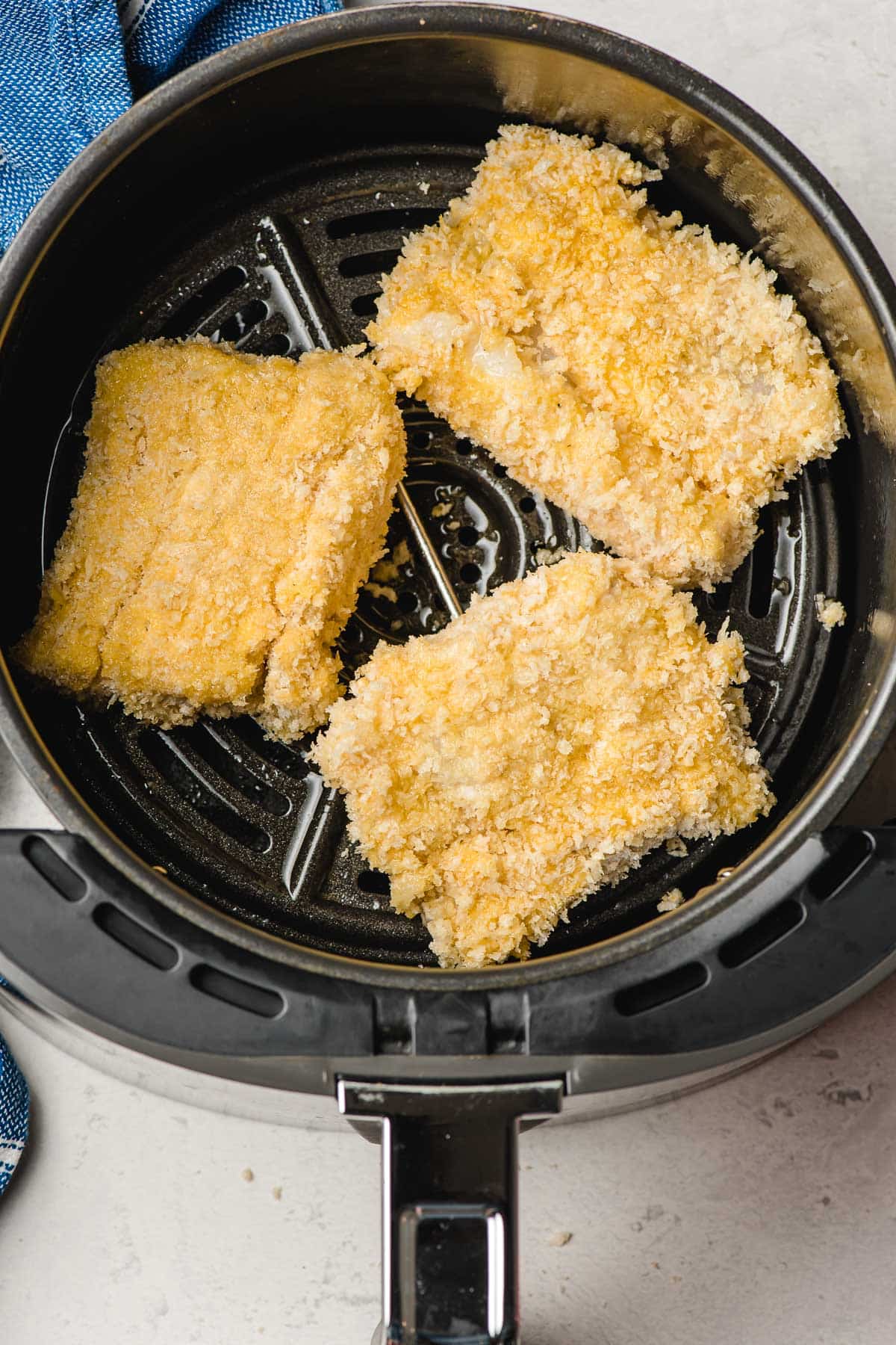 three cod fillets in an air fryer