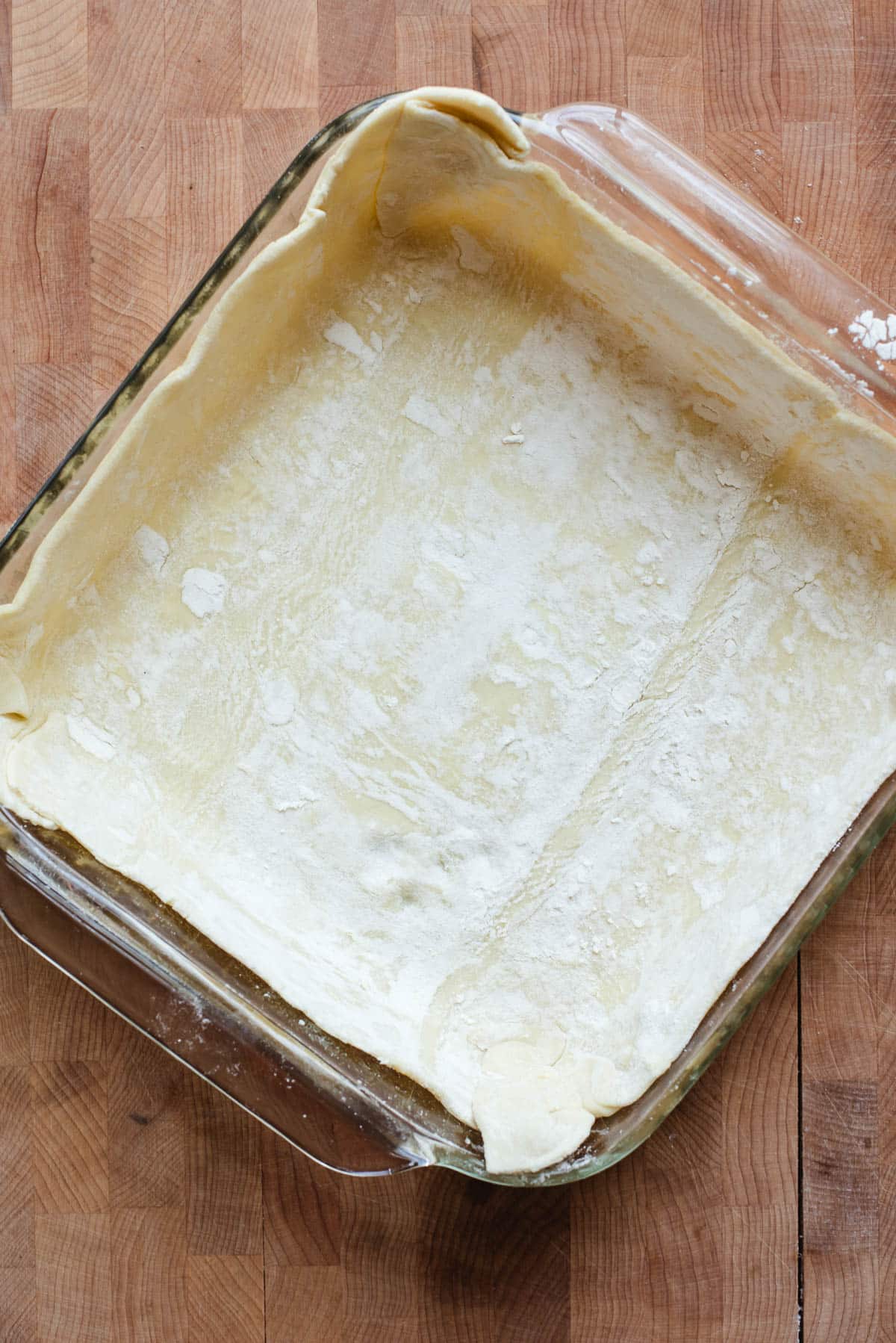 Puff pastry pressed into a square glass dish.