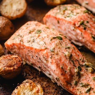 Baked salmon and potatoes on a sheet pan.