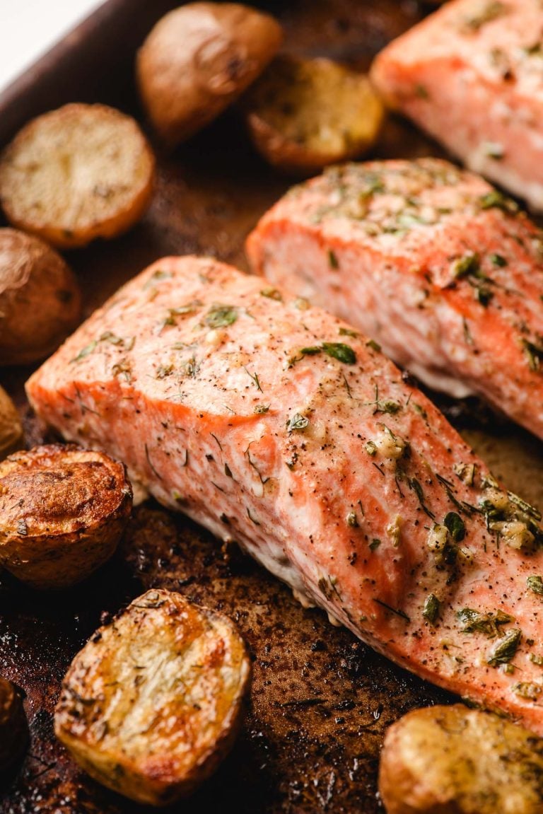 Baked salmon and potatoes on a sheet pan.
