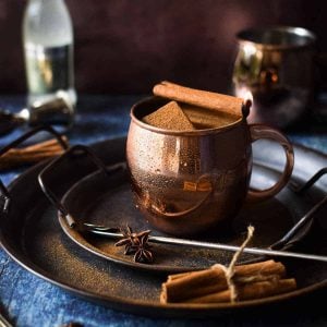 Chai Moscow Mule in a copper mug, topped with cinnamon.
