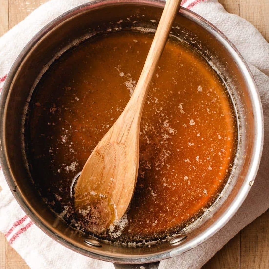 Maple syrup stirred into butter in a sauce pan.