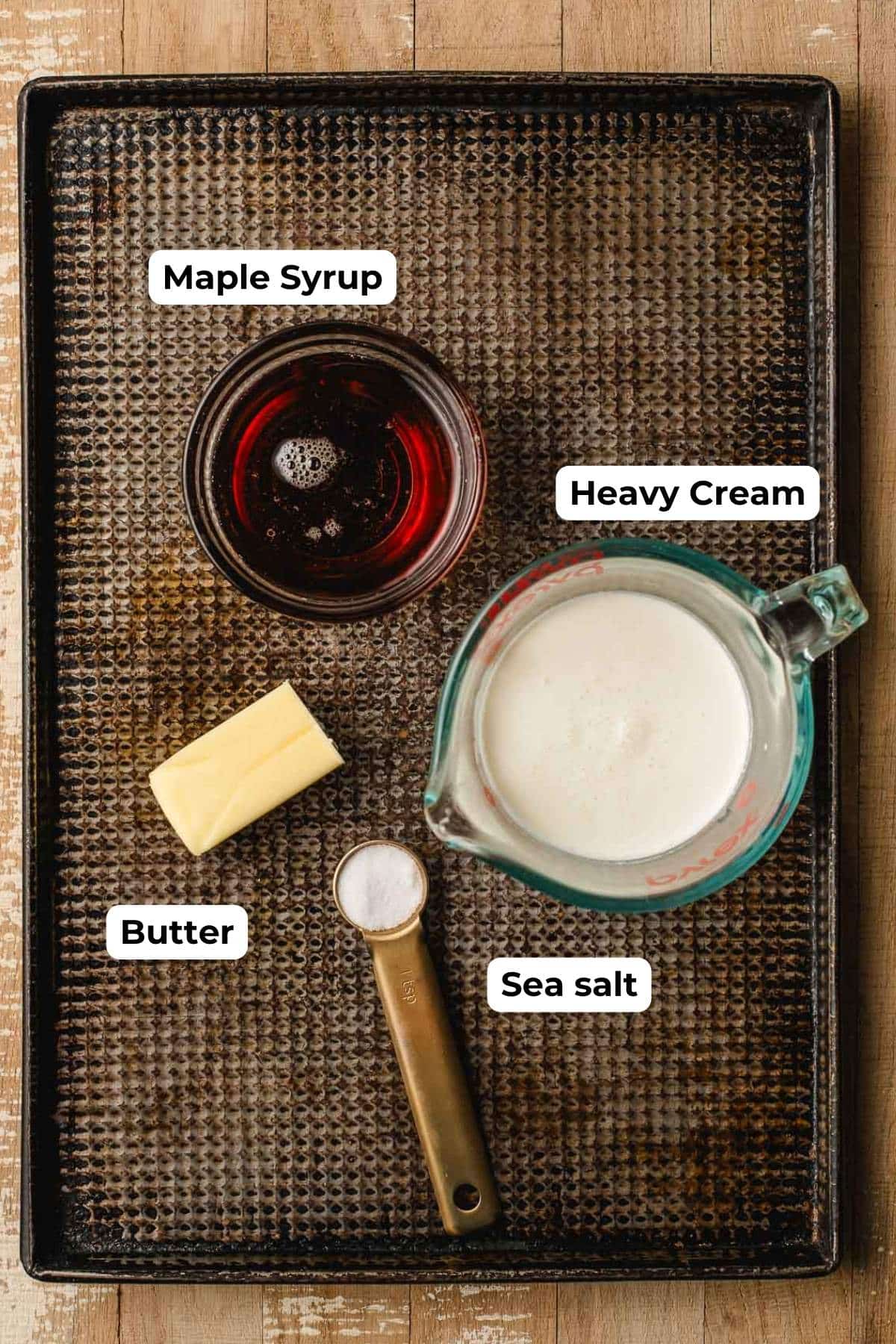 Maple syrup, cream, butter, and salt on a sheet pan.