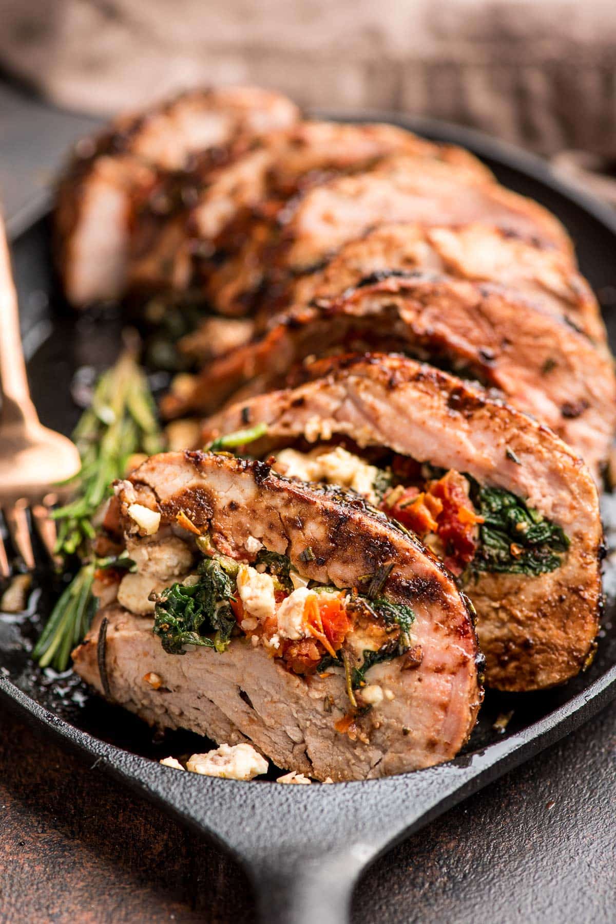 sliced pork tenderloin stuffed with spinach, feta, and sun-dried tomatoes.