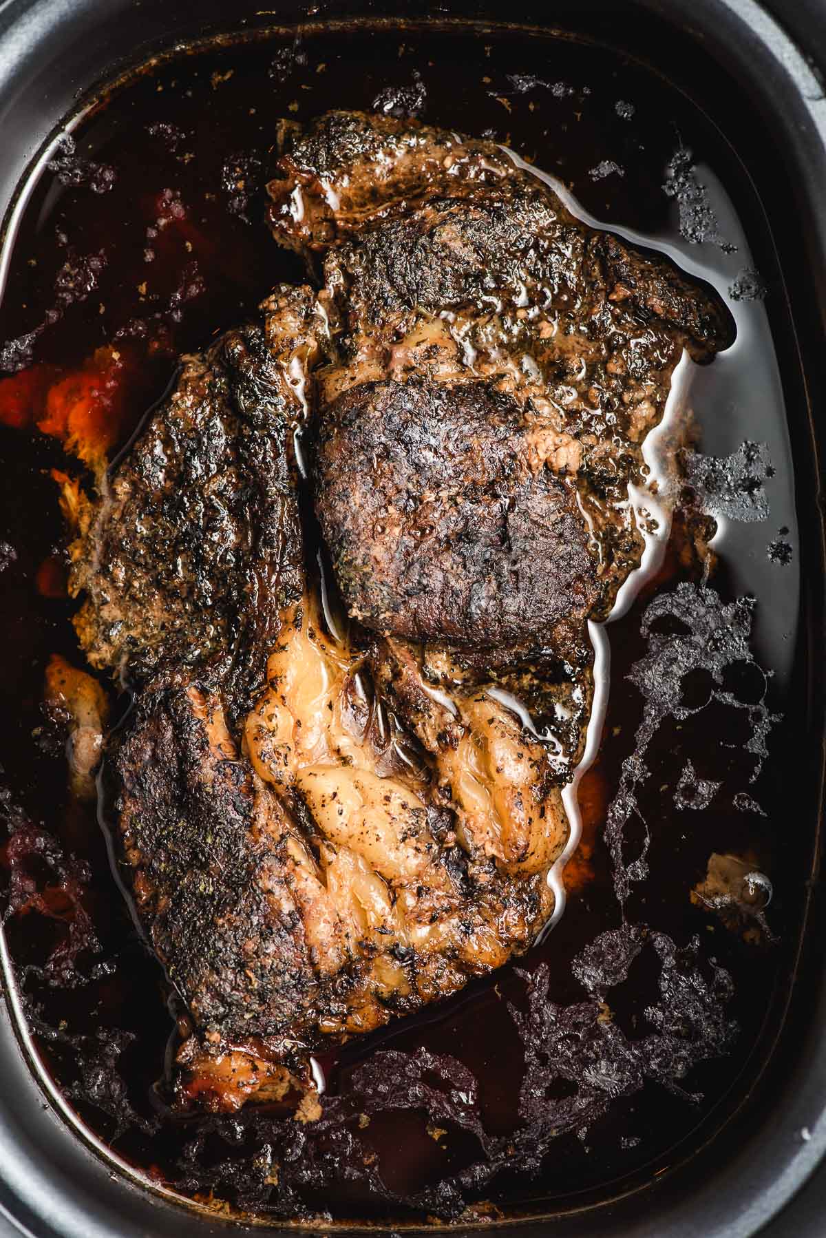a cooked roast in the crock pot ready to be removed. 