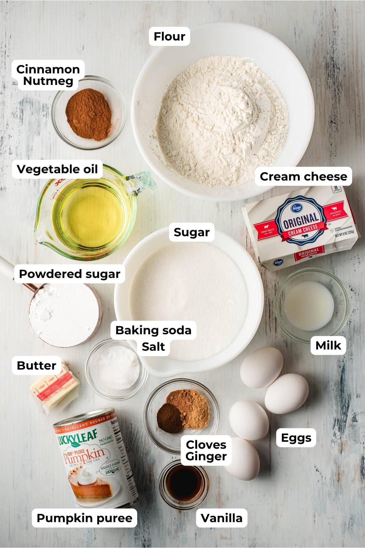 Ingredients to make cream cheese frosted pumpkin bread in prep bowls.