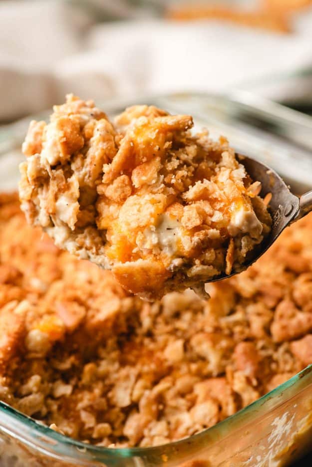 Spoon scooping up a serving of Ritz chicken casserole.