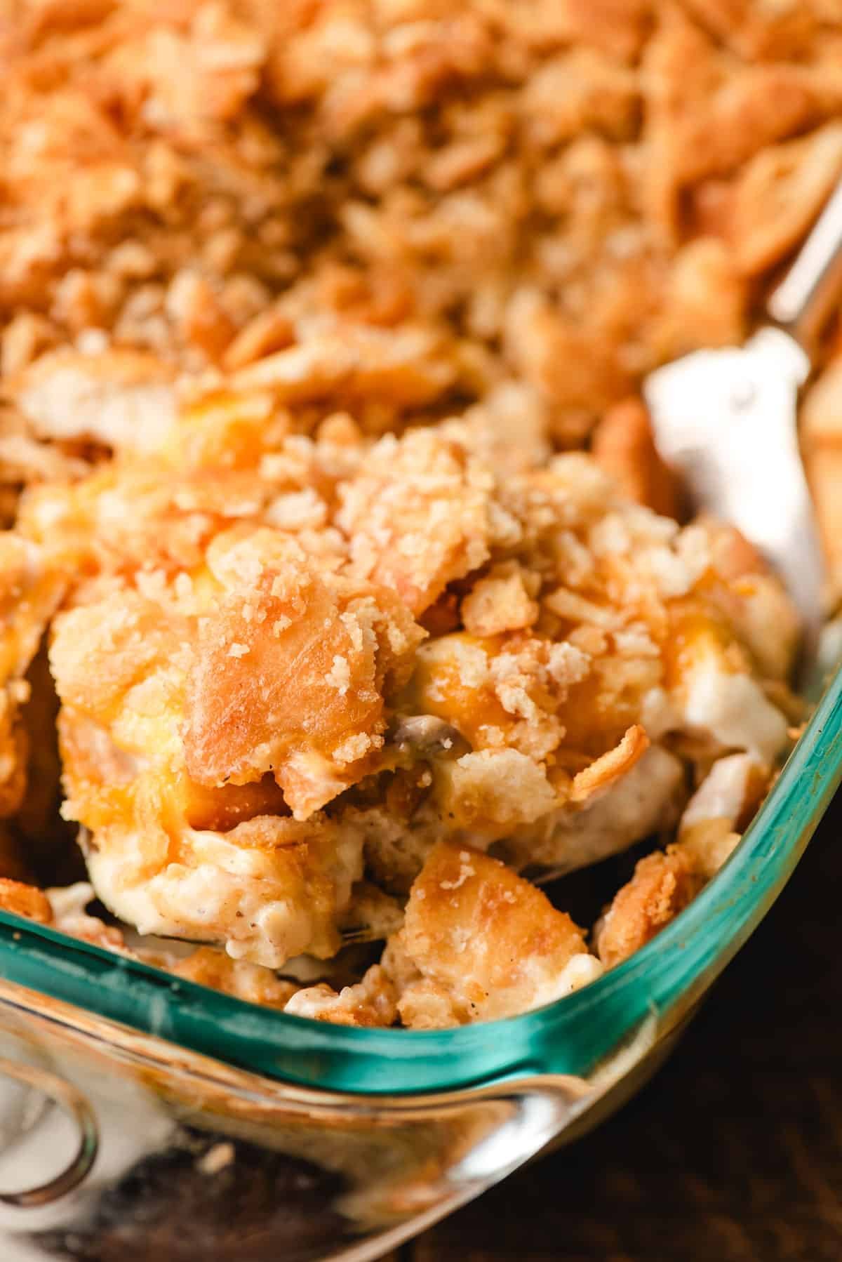 Spoonful of chicken casserole topped with Ritz crackers.