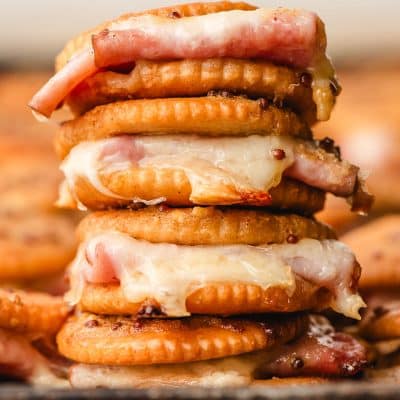 Stack of ham and cheese ritz cracker sandwiches.