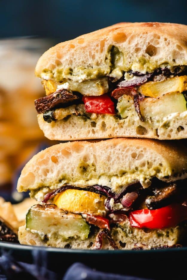 Sliced roasted vegetable sandwich stacked on top of each other.