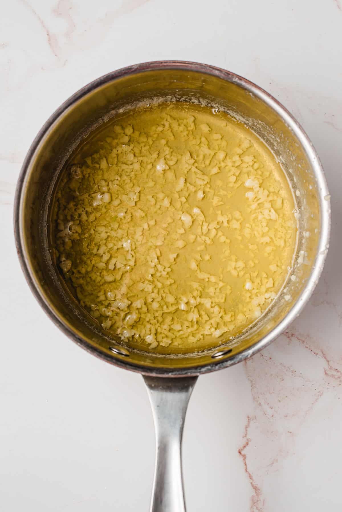 Melted butter and garlic in a saucepan.