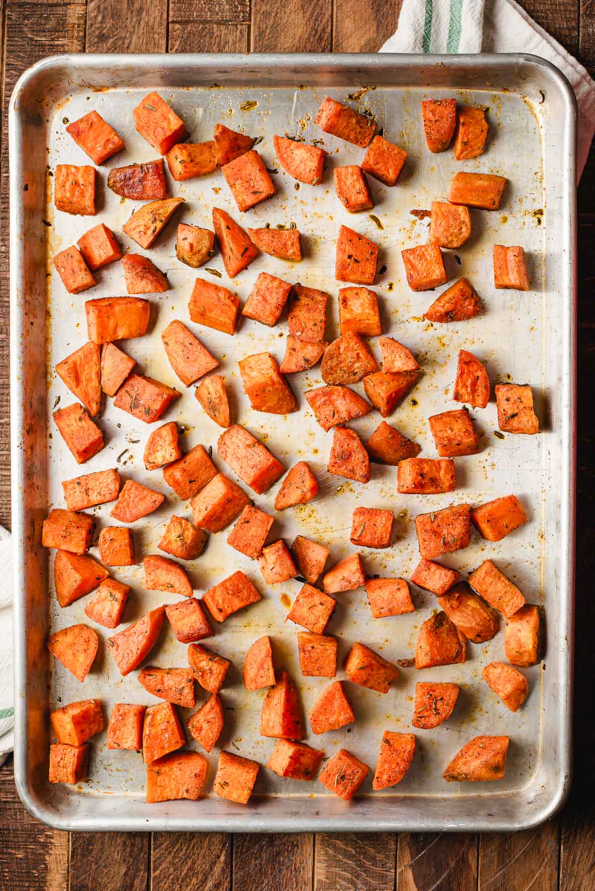 Rosemary roasted sweet potatoes on a sheet pan.