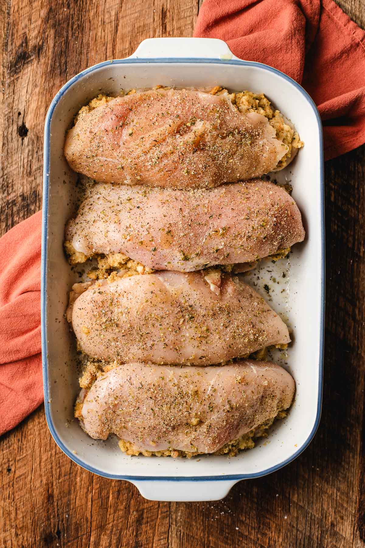 seasoning the tops of the stuffed chicken breast