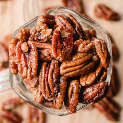Candied maple pecans in a pretty glass dish.