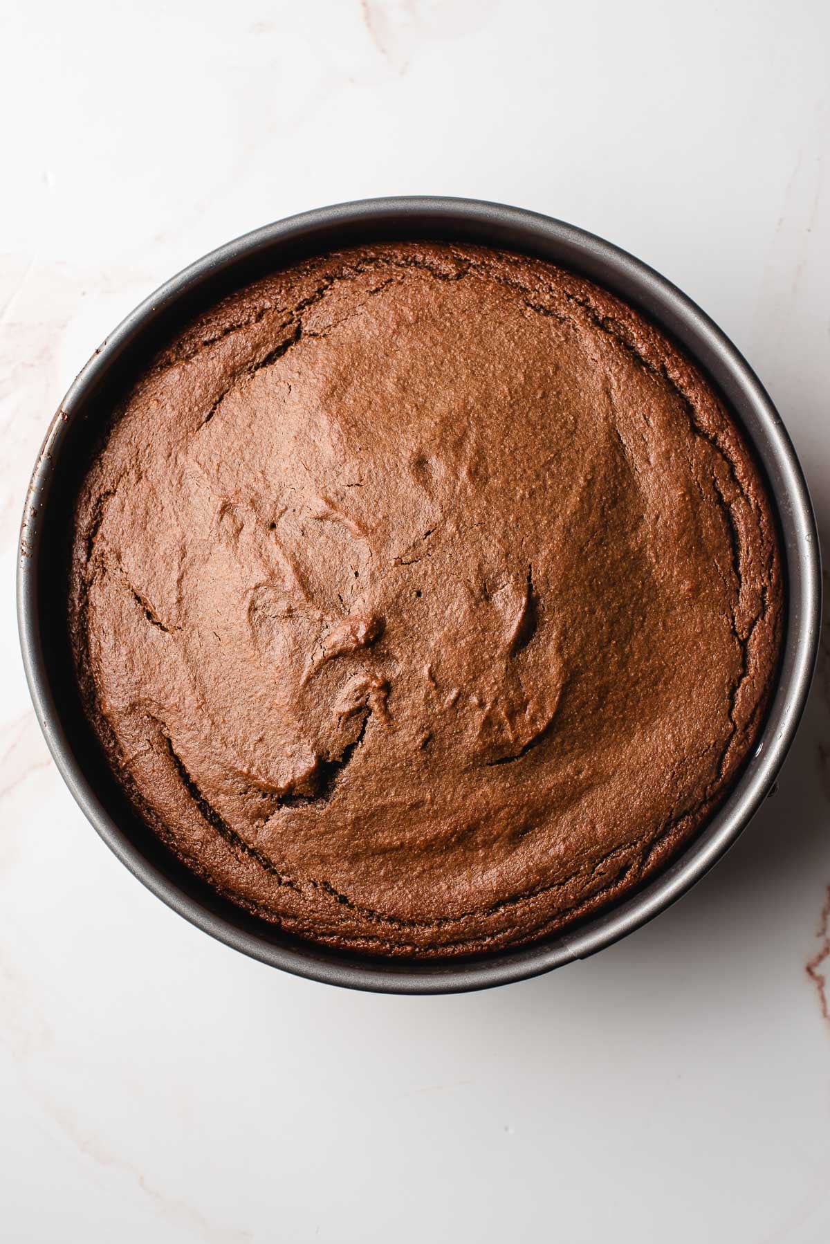 the baked chocolate orange cake cooling in the pan
