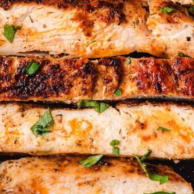 Perfectly seared chicken breast slices lined up.