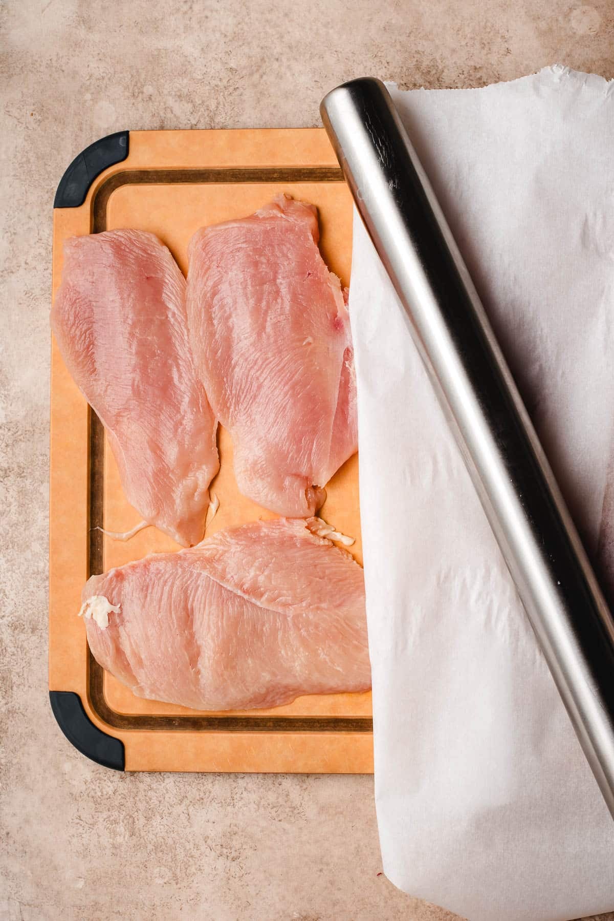 slicing chicken into thin cutlets