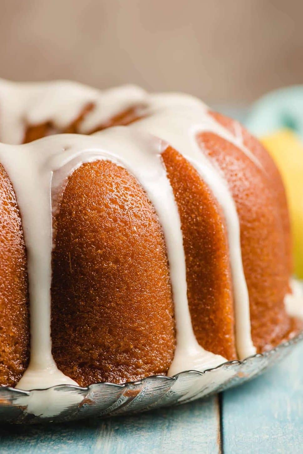 Iced Lemon Bundt Cake on a glass platter.